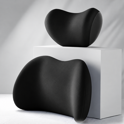 Black ergonomic lumbar support cushion and neck pillow displayed on a white pedestal
