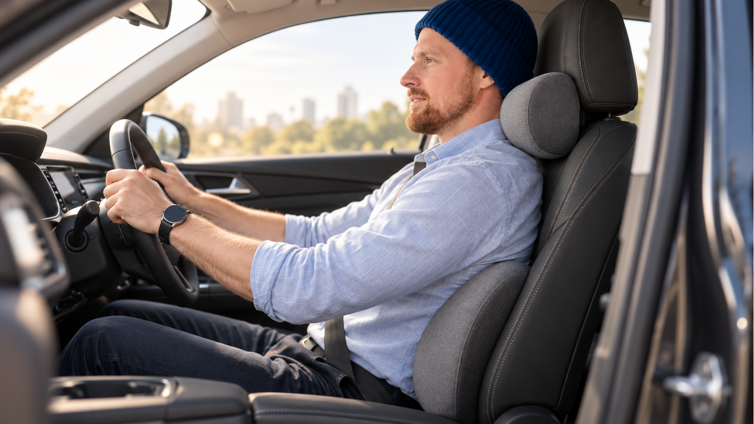 Male driver using the Driver’s Comfort Kit with lumbar and neck support cushions installed in a modern car seat.